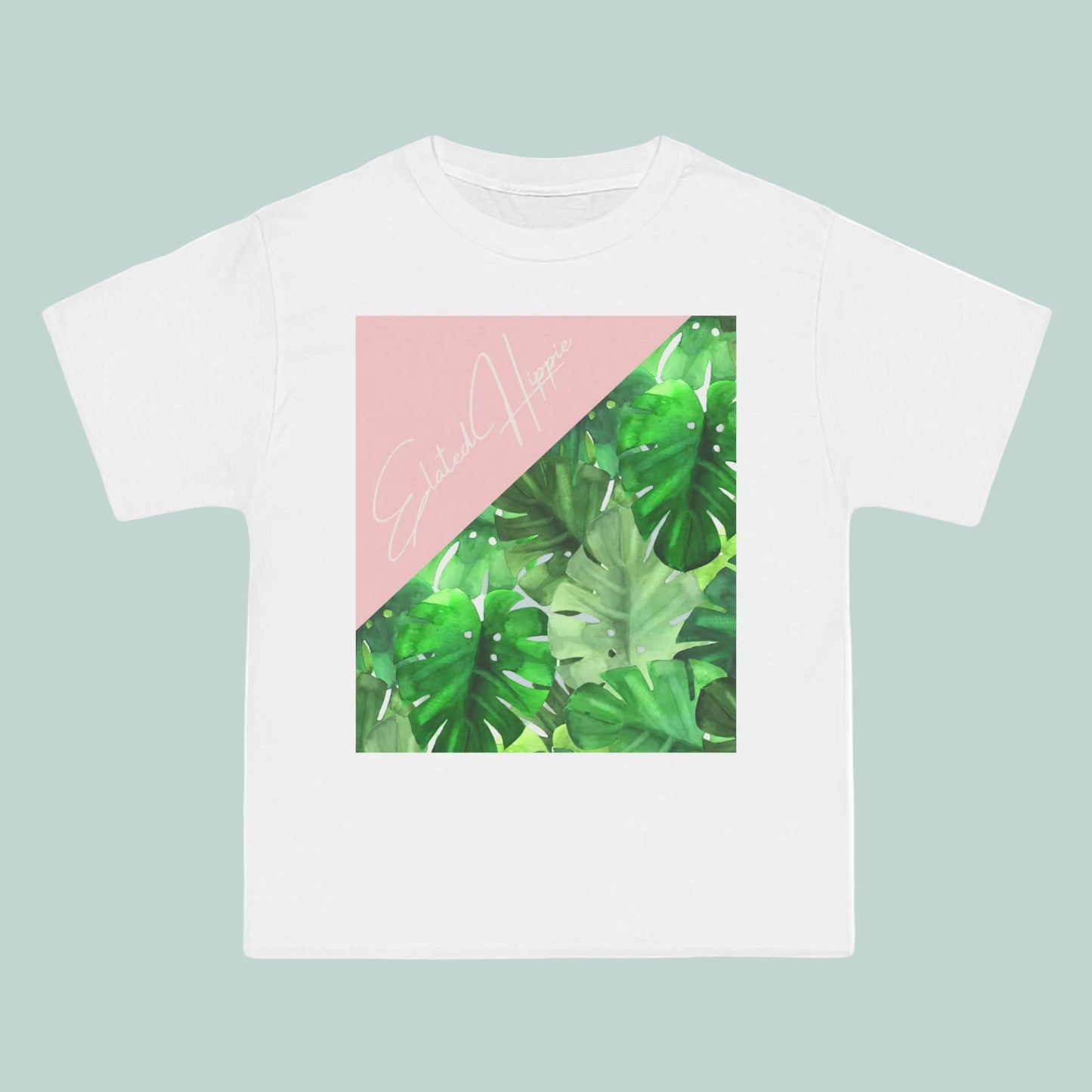 White t-shirt with green leaf pattern and pink triangle on a white background